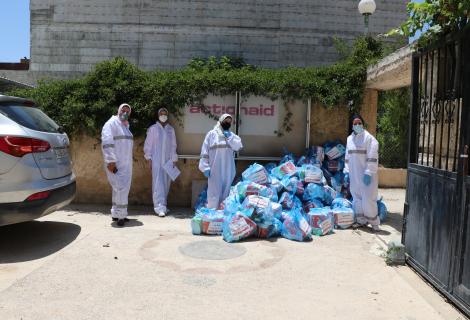 ( photo of ActionAid Palestine staff members while they are preparing hygiene kits provided by AAO to b distributed on the families staying in home health quarantine in Hebron Governorate to respond to the second wave of the outbreak of corona virus in occupied Palestinian territories)
