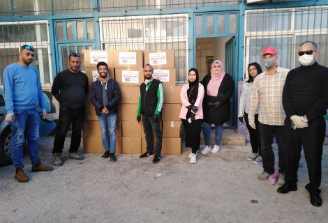 Youth volunteers in Walajeh in Bethlehem in the south West Bank through the distribution of preventive and hygiene kits to the affected families within youth initiatives supported by AAP to respond to the needs of the Palestinian community to combat COVID-19