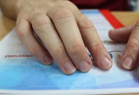 Young man is reading a booklet designed on Braille system which contain information about safety measures of COVID-19. Producing Braille booklets is one of the achievements of a youth-led initiative supported by AAP’s programme of “Civil and Democratic participation of Palestinian Youth” in Partnership with MASARAT center.