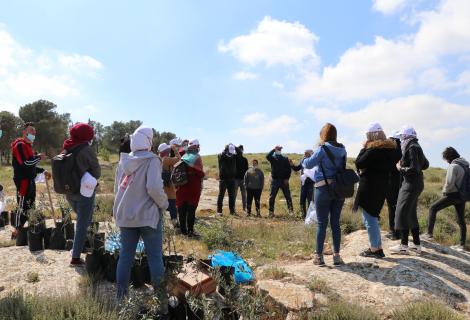 Photo of youth while they are volunteering to plant olive trees to help Palestinian farmers on the occasion of Land Day in Twaneh in the south of West Bank -Copy rights for ActionAid Palestine 2021)