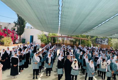 Photo of Palestinian female students during the first day after the start  of the new school year 2021\2022 in Occupied Palestinian Territory Al-Kom Village -Hebron Governorate in the south of West Bank -Palestine 
