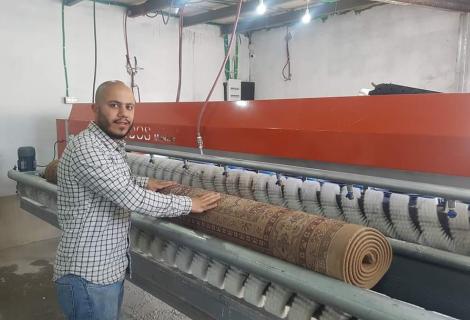 Photo of Mohammad Hjoj who is a young entrepreneur and owner of “ Ratib Omurak” in Al-Fwwar refugee camp in Hebron Governorate in the south of West Bank