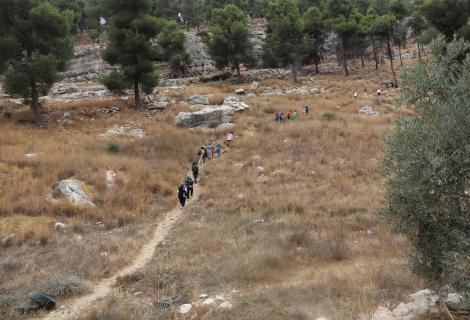 Photo of youth participating in Palestinian Earth walk in Wadi Al-Kuf reserve in Hebron Governorate in the south of West  in solidarity  with Palestinian Natural reserves a   head of UN climate  UN Climate Change Conference (COP 26) in Glasgow- West Bank -Palestine -Copy Rights to ActionAid Palestine -2021    