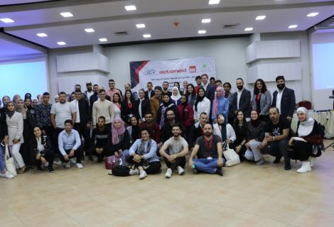 Photo of young people, staff members of ActionAid Palestine and her excellency , Palestinian minister of Women Affairs and representatives of partners senior country program adviser at representation of Denmark to the Palestinian Authority during the closing ceremony of project of “ Civil and Democratic Participation of Palestinian Youth “that ActionAid Palestine  launched in 2018  and implemented in partnership with   Alternative Information Center,  the Palestinian Center for Policy Research and Strategic