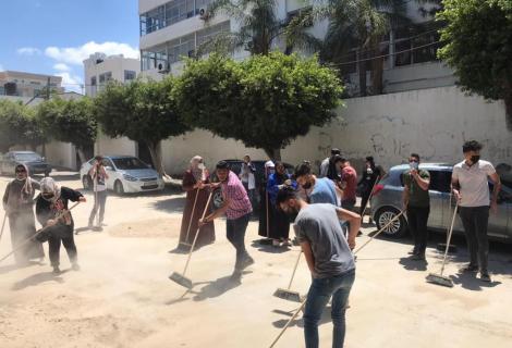 Photo of young people during their participation in national campaign titled with “ We will Rebuild it’ for cleaning Gaza from rubbles after end Israeli war against Gaza -Gaza Strip- Palestine -2021