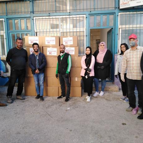 Youth volunteers in Walajeh in Bethlehem in the south West Bank through the distribution of  preventive and hygiene kits to the affected families within youth initiatives supported by AAP to respond to the needs of the Palestinian community to combat COVID-19  