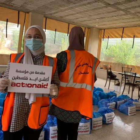 (photo of young women while they were packaging hygiene kits to be distributed on families in home quarantine in the town of Beit Kahel and Halhoul under AAP’s emergency to the second wave of the outbreak of COVID-19 in Hebron Governorate)  