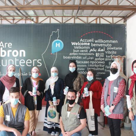 Photo of young people  from ActionAid Palestine youth groups launching  their campaign titled with “Plastic-Free Palestine” to Combat Climate Change by distributing  cloth bags and glass cups  to consumers in commercial shops and organizations and  educational brochures making them aware of the evils of plastic bags, promoting the re-use of cloth bags-Hebron in the South of West Bank - Copy Rights for ActionAid Palestine 2020 