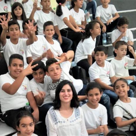 photo of Mai Al-Qaisi  who was appointed “Save our Future” s Global Ambassador to Defend Right of Palestinian children to Education while she was implementing musical activities Palestine refugee children in Deheisha camp for refugees near Bethlehem -in the south of West Bank-Palestine 2020 
