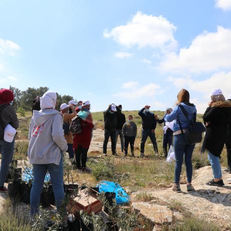 Photo of youth while they are volunteering to plant olive trees to help Palestinian farmers on the occasion of Land Day in Twaneh in the south of West Bank -Copy rights for ActionAid Palestine 2021)