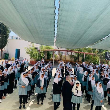 Photo of Palestinian female students during the first day after the start  of the new school year 2021\2022 in Occupied Palestinian Territory Al-Kom Village -Hebron Governorate in the south of West Bank -Palestine 